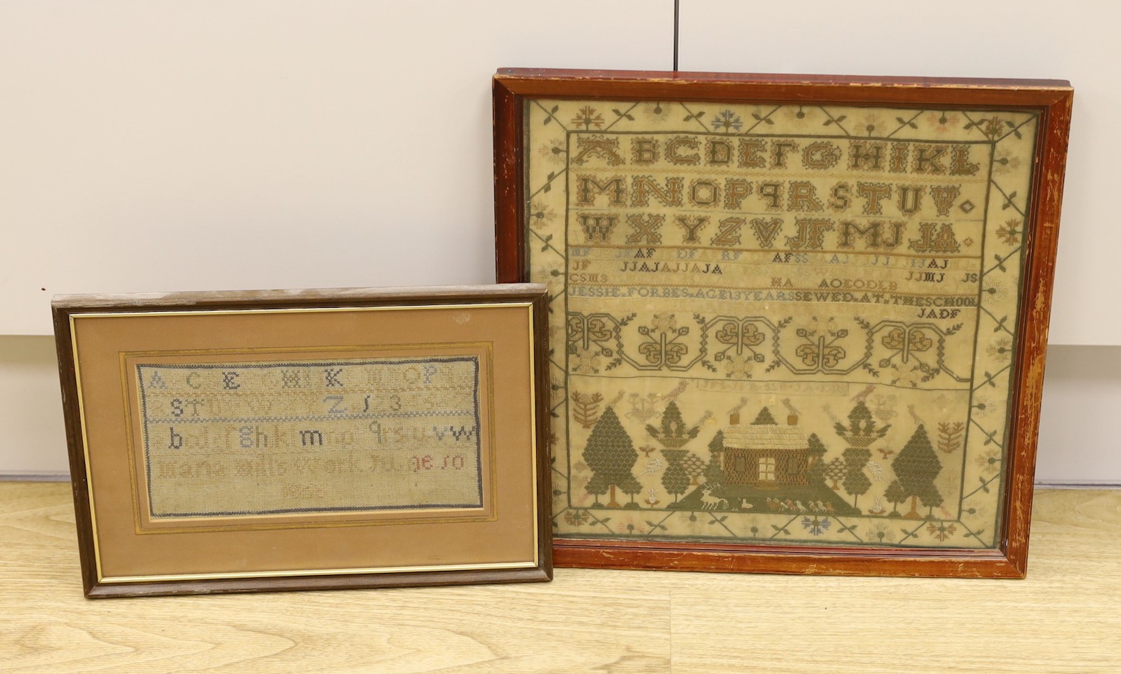 A 19th century cross stitch alphabet sampler, lower panel, depicting a house birds and trees, together with a later sampler-, 19th century sampler 33cms square.